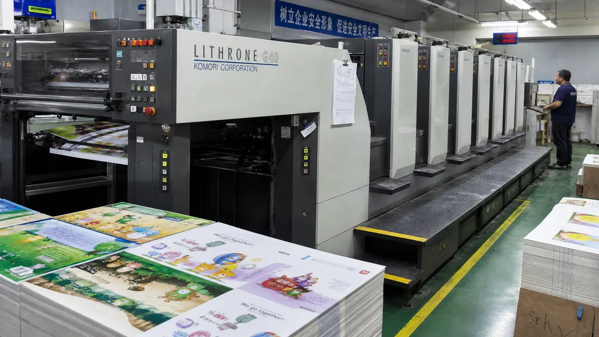Offset printing press running board book sheets in a Chinese printing factory