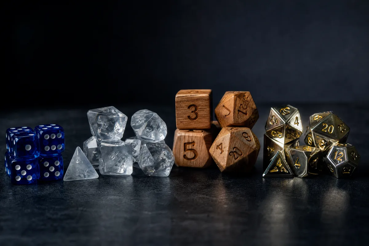 Custom dice types comparison: acrylic dice with pad printing, engraved resin dice, wooden dice, and metal dice with enamel fill