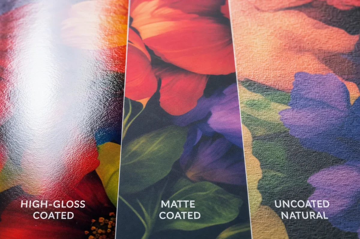 Closeup comparison of gloss coated, matte coated, and uncoated poster paper surfaces showing texture differences